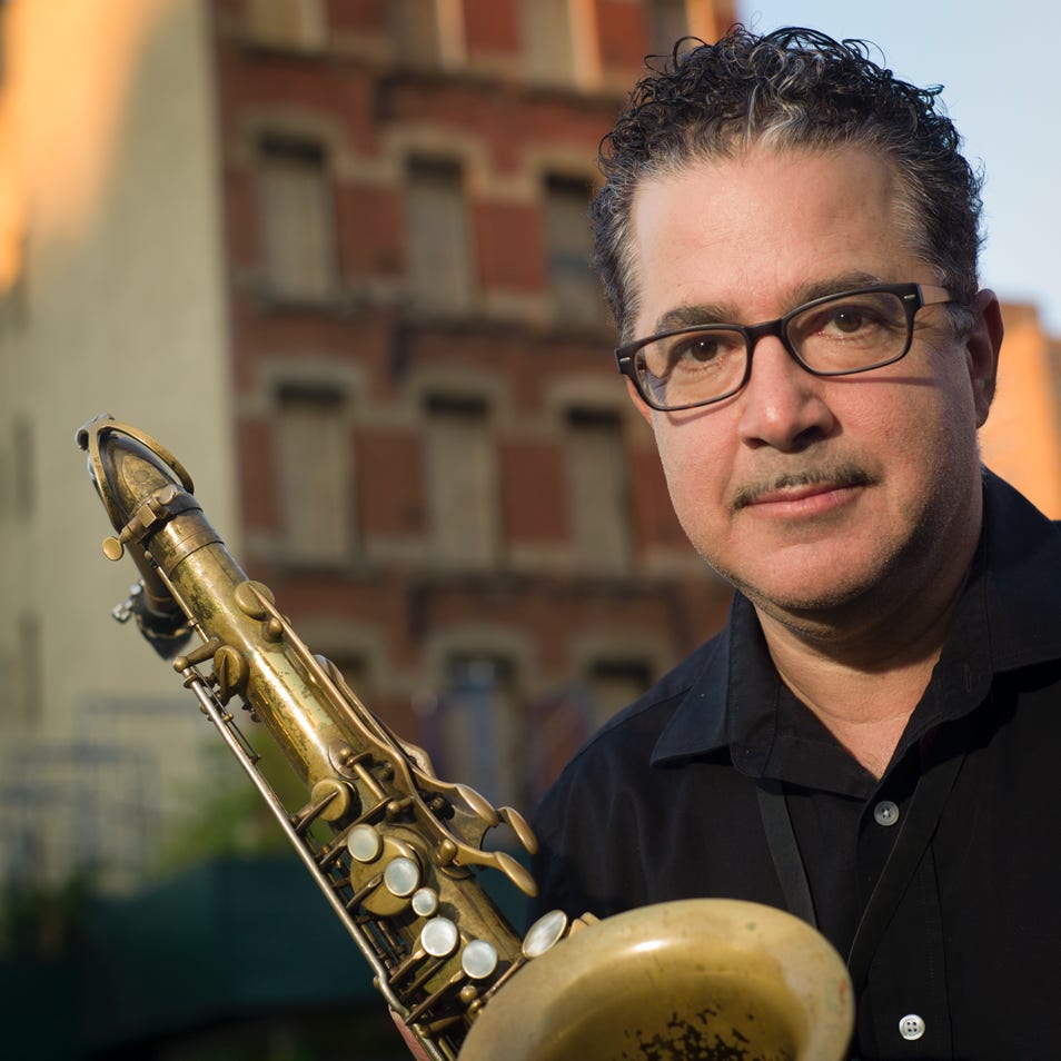 Photo of Paul Shapiro with the building that Sonny Rollins building on Grand Street. 